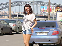 Cute teen girl shows off her legs while wearing a pair of short denim shorts and sneakers in this video of her walking down the street.
